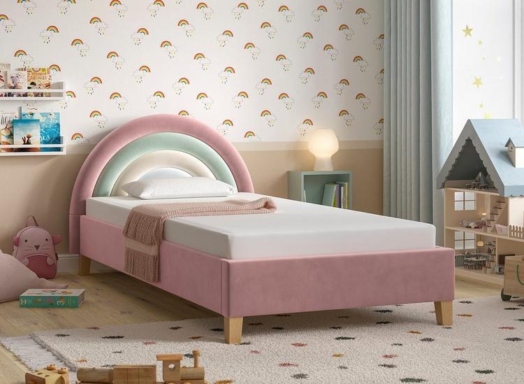 A pastel rainbow-design toddler bed, styled in a colourful kids room with rainbow-print wallpaper.