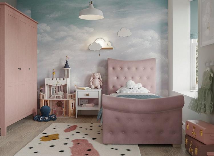 A pink velvet single kids sleigh bed, with storage drawer, styled in a whimsical pastel-tone kids room.