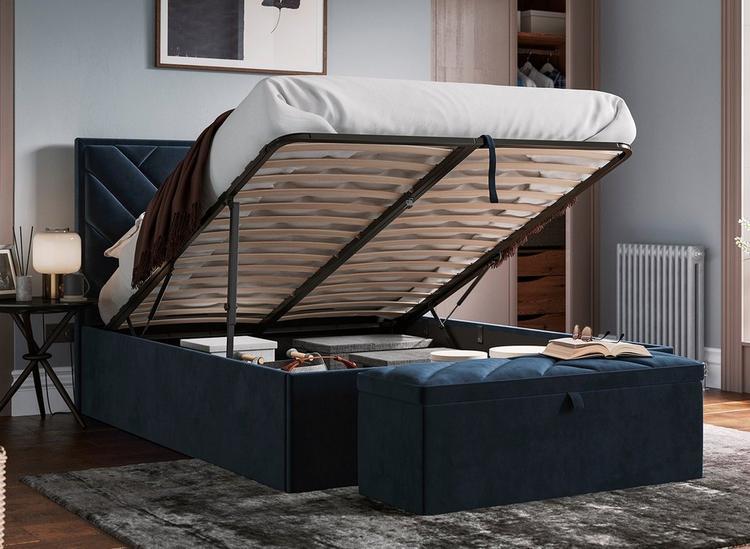 Navy blue ottoman bed with matching blanket box, styled in a neutral blue room.