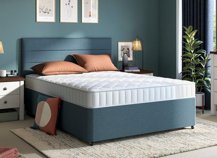 Brushed twill divan base in mid-blue tone, styled in a blue bedroom with orange accessories
