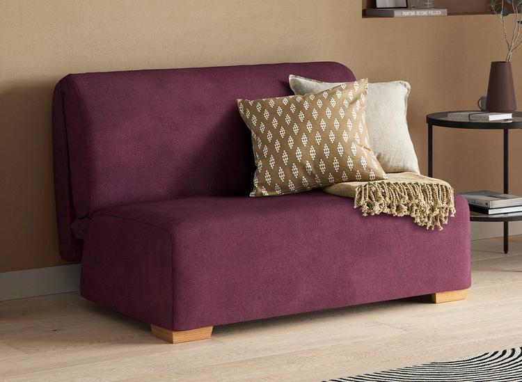 Cork Double A-Frame Sofa Bed, styled with gold pillows and a throw blanket.