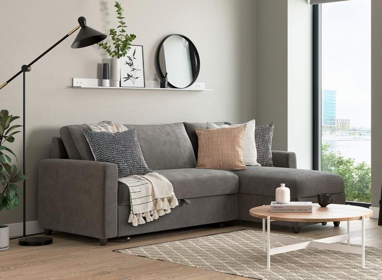 the limerick 3 seat corner sofa bed in smoke, a grey colour, styled in a modern apartment.