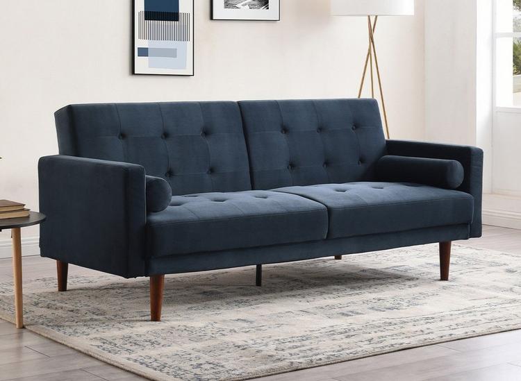 Navy blue velvet sofa bed, styled in a white neutral room.
