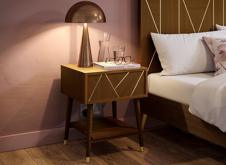 Dark wooden bedside table with gold metallic inlays, styled in a deep pink feminine bedroom.