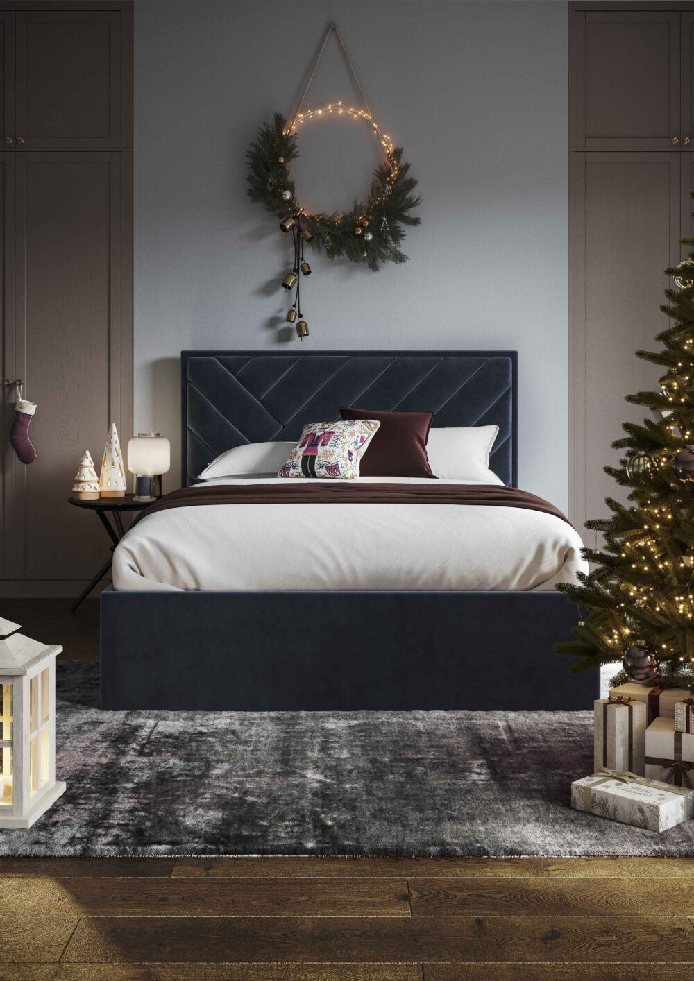 A navy blue upholstered bed frame, styled in a festive blue room
