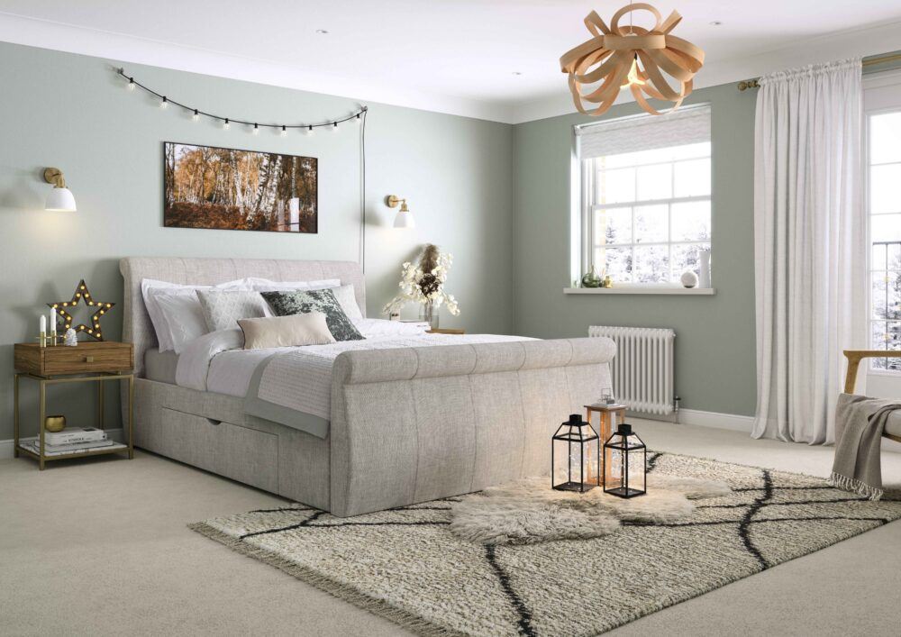 Neutral grey bed frame, styled in a festive room with soft natural accents.