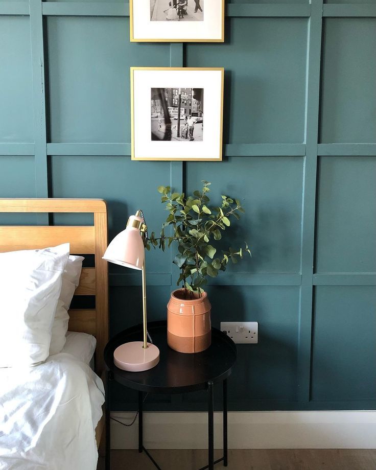 Wooden bed frame with teal, blue-green walls @501.properties