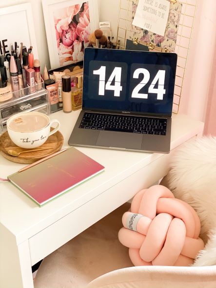 dressing table turned into a desk with laptop and makeup on top