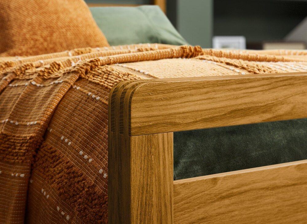 warm woods woodstock bed against dark green bedding and walls