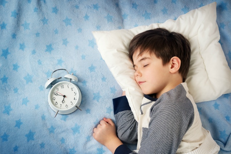 An image of a child sleeping with a pillow