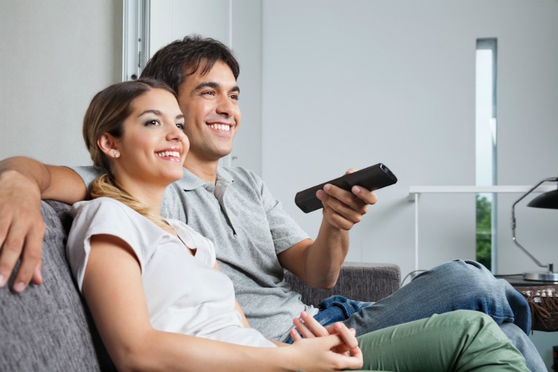 image of happy couple watching tv