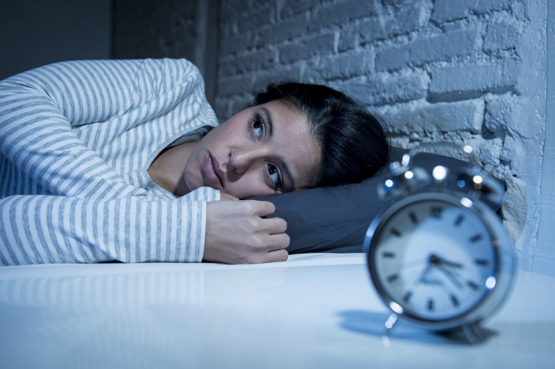 Image of woman stressed in bed
