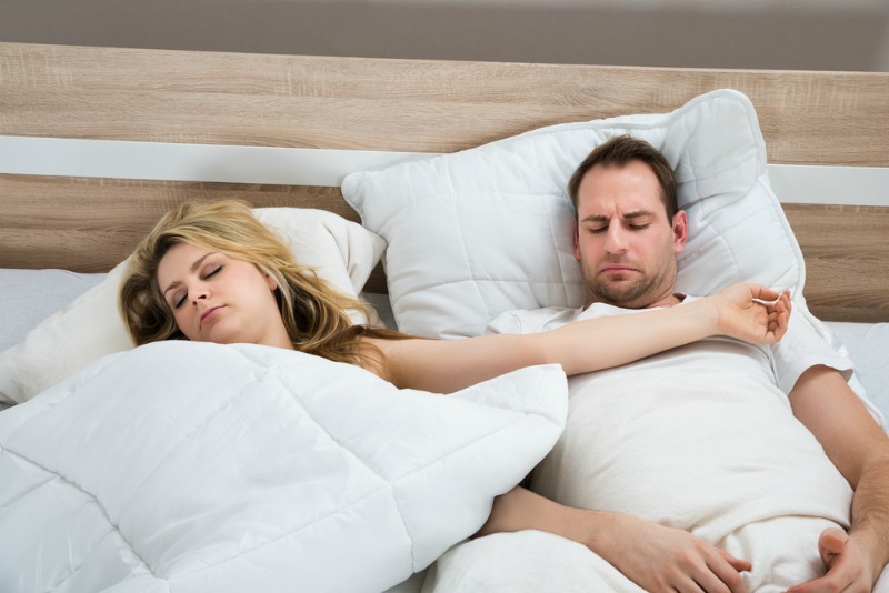 image of couple uncomfortable in bed