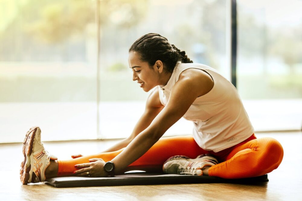 Young female stretching before workout