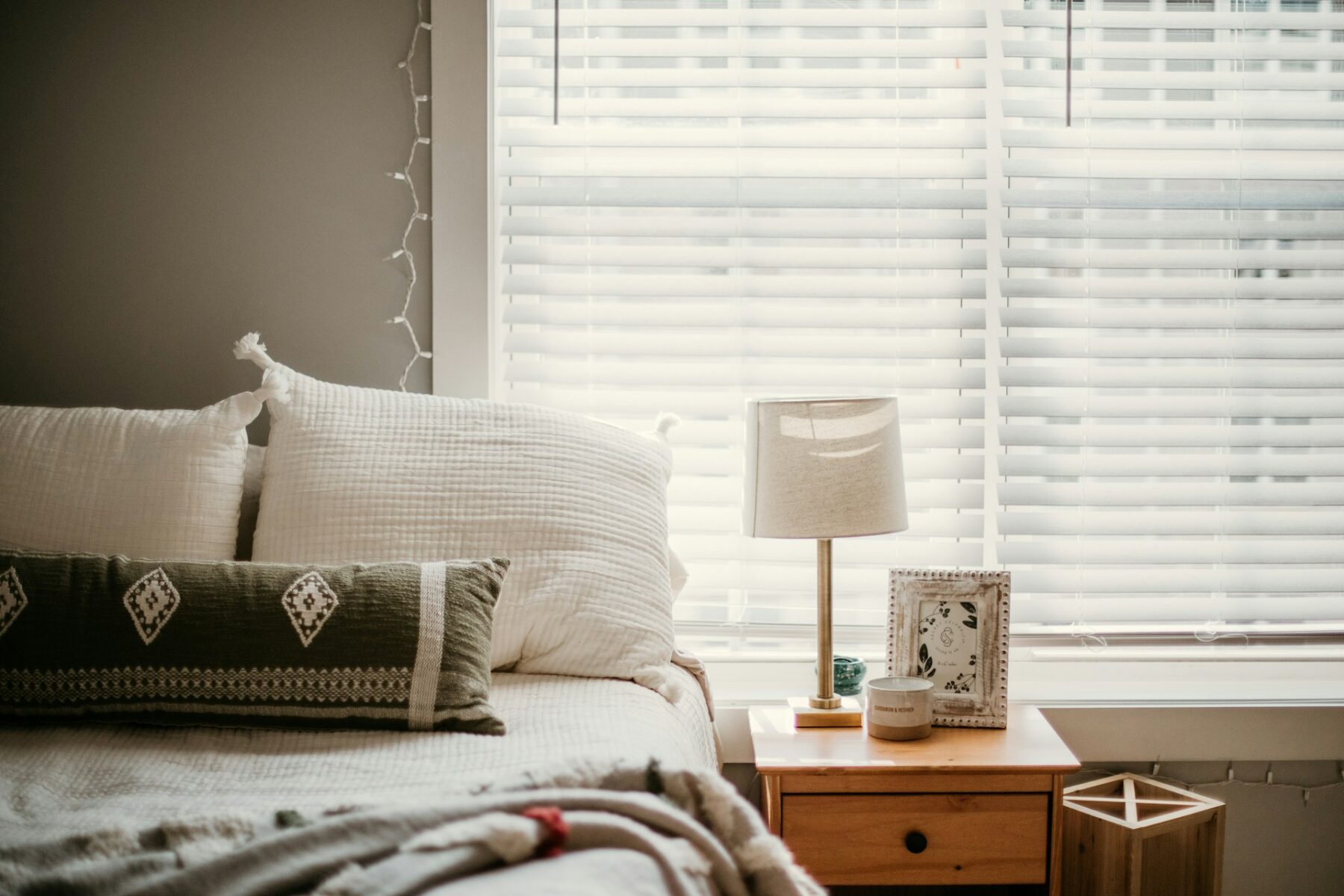 A bedroom with blinds blocking out sun heat