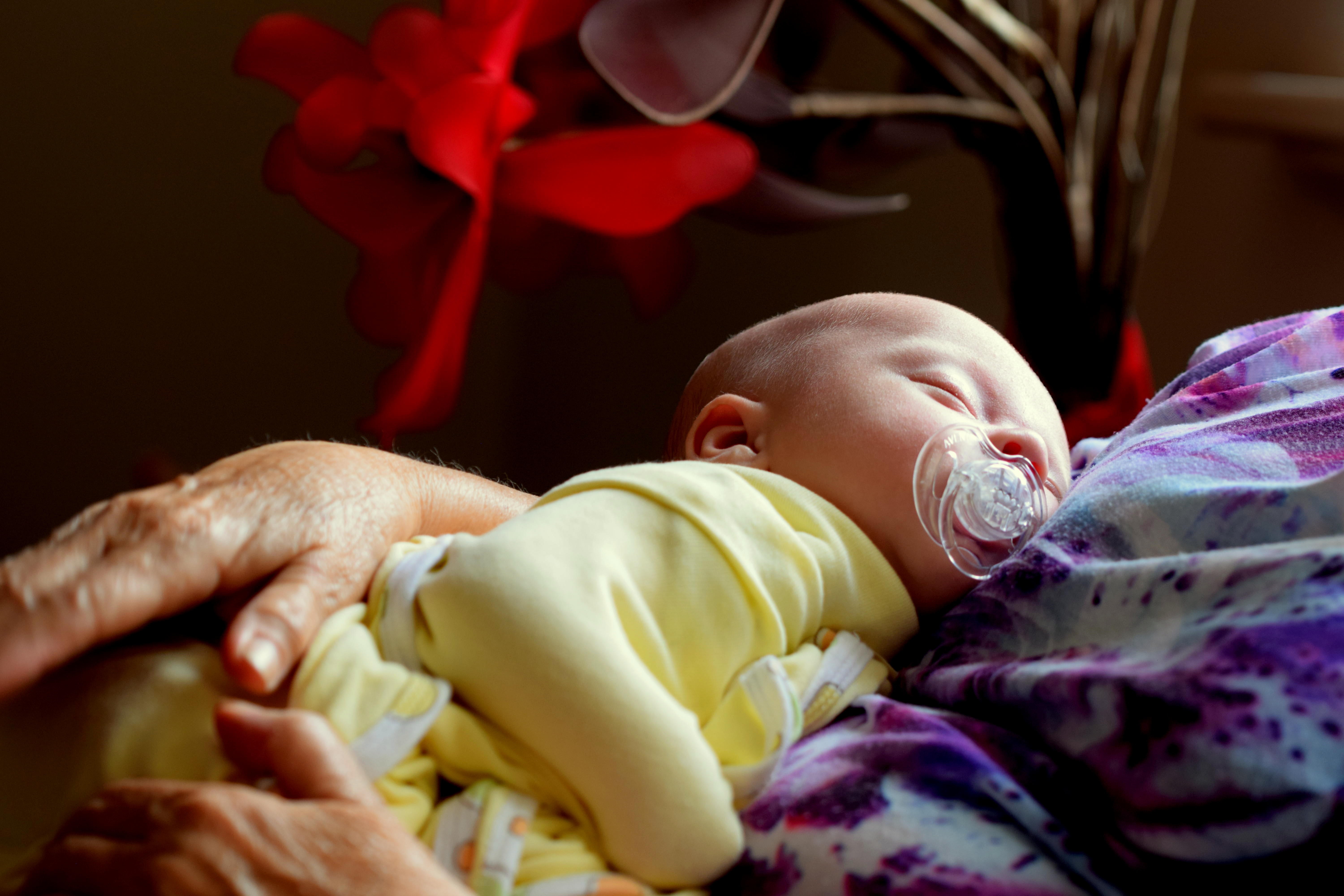 sleeping baby in arms