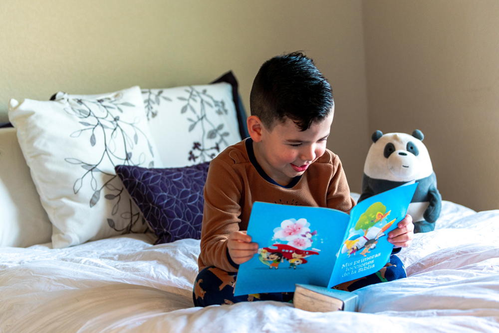 boy reading on a bed