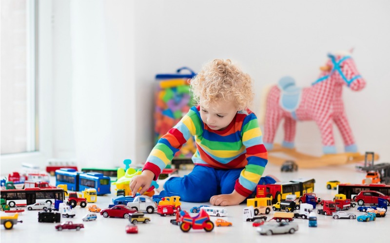 Child playing in messy bedroom