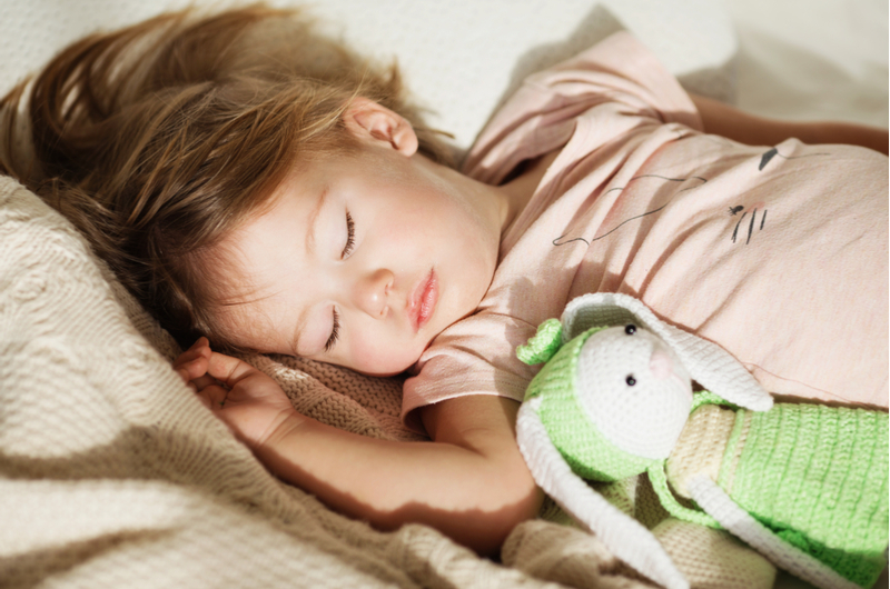 child sleeping with comfort toy