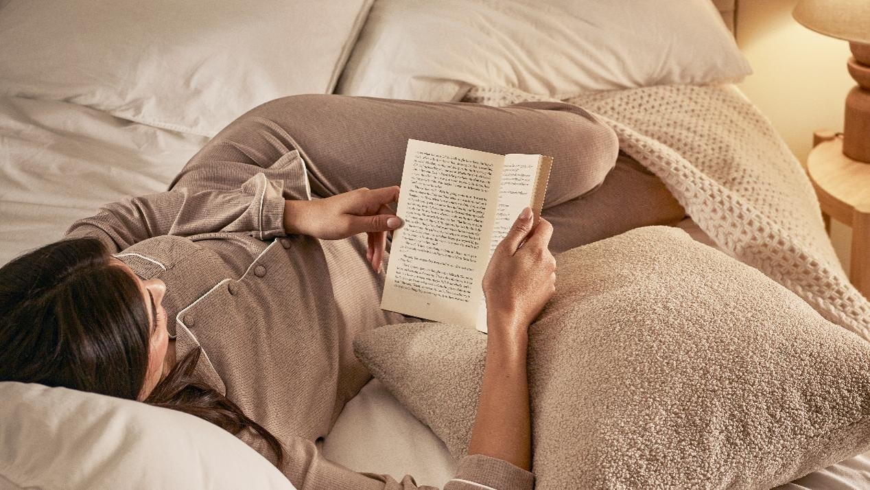 Woman reading a book in bed