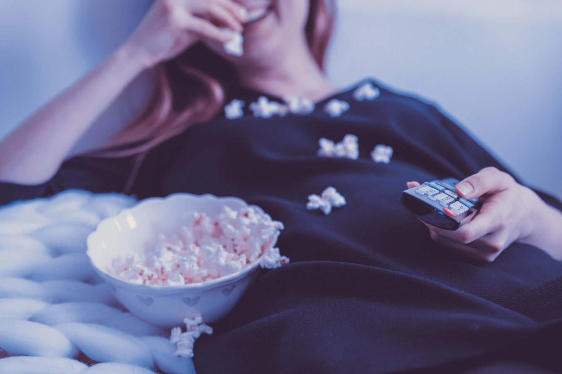 Woman watching film with popcorn