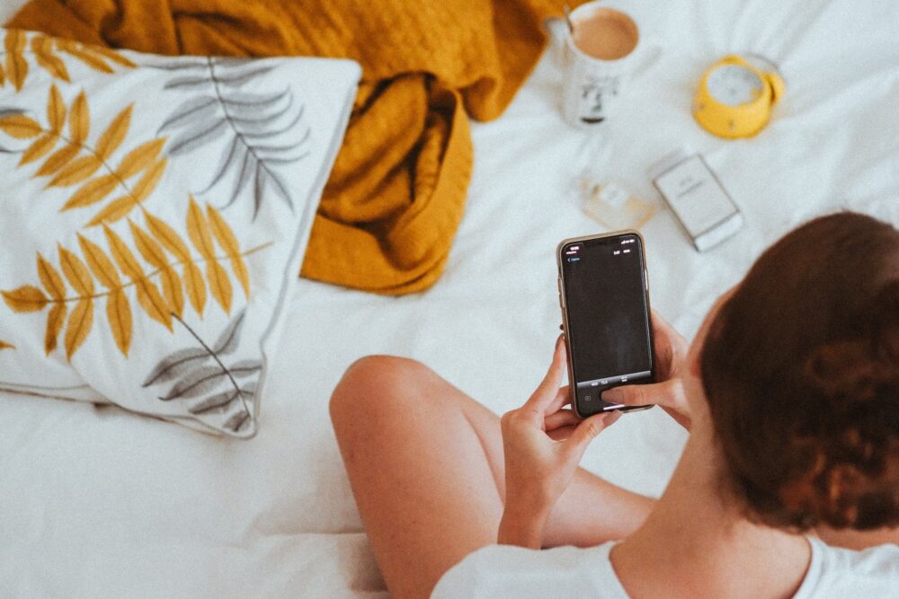 Woman on phone in bed