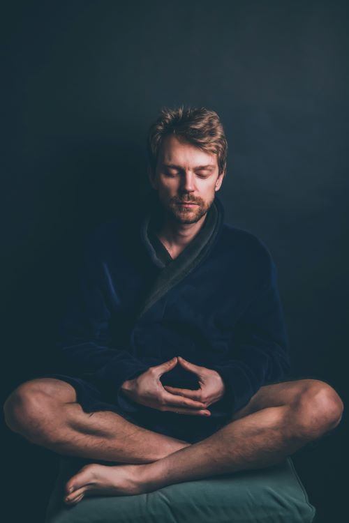 a man meditating before bedtime to achieve clean sleep