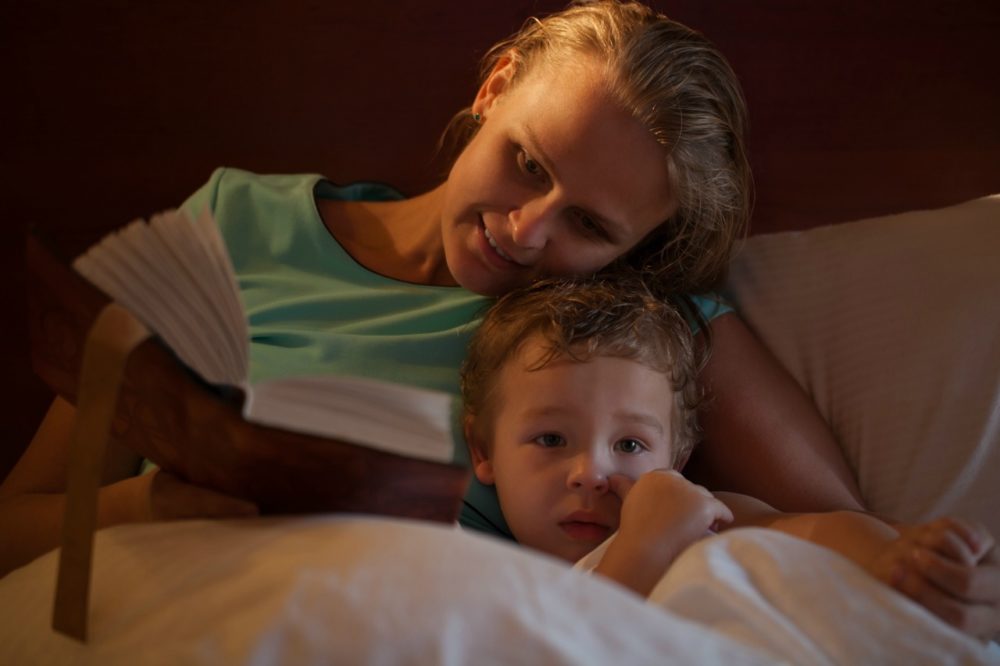 mum reading story to child