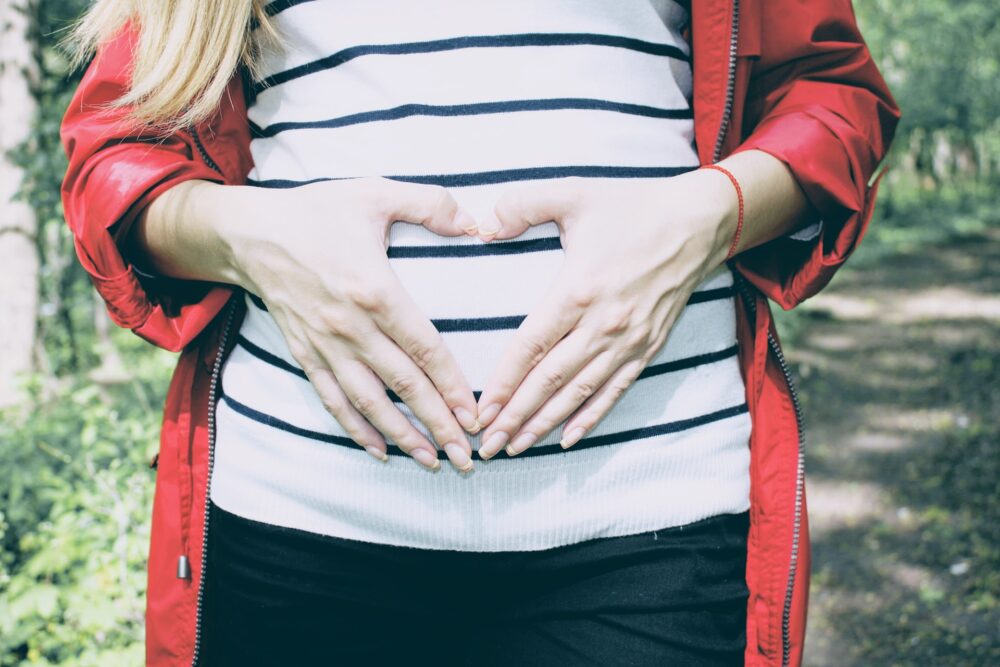 Woman holding pregnant belly