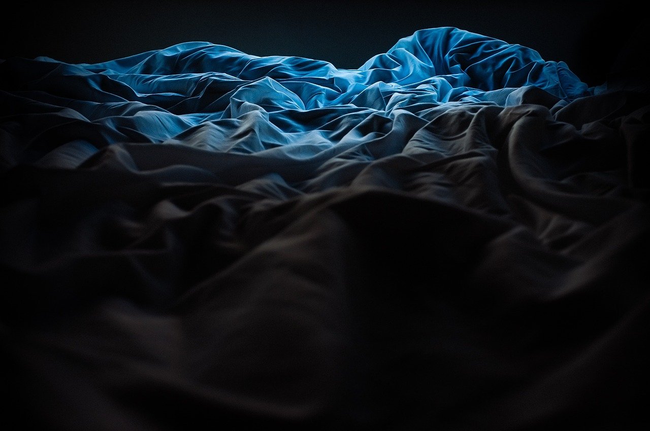 image of bedsheets with coloured light