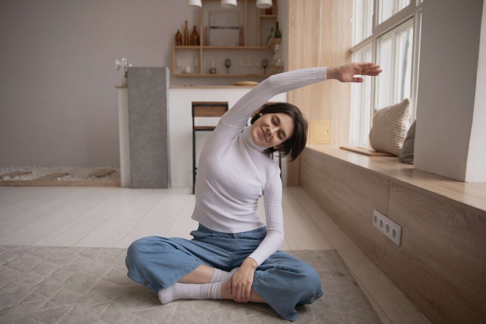 woman stretching whilst sat down