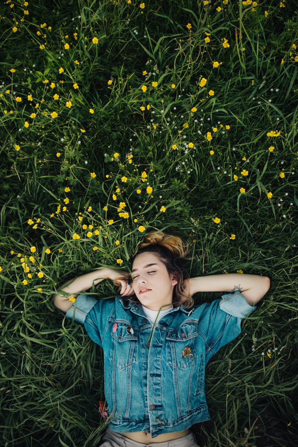 woman asleep in field of grass