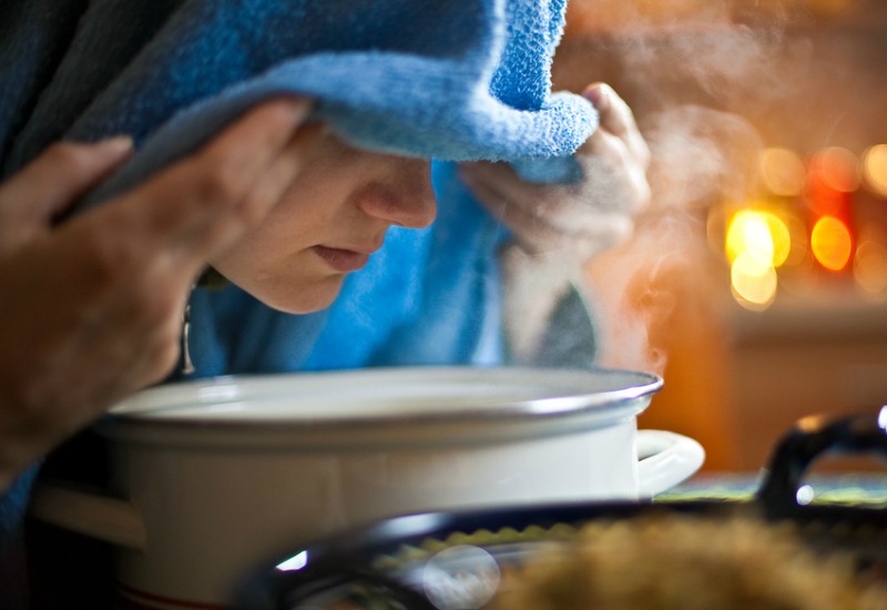 Woman steaming face over a bowel