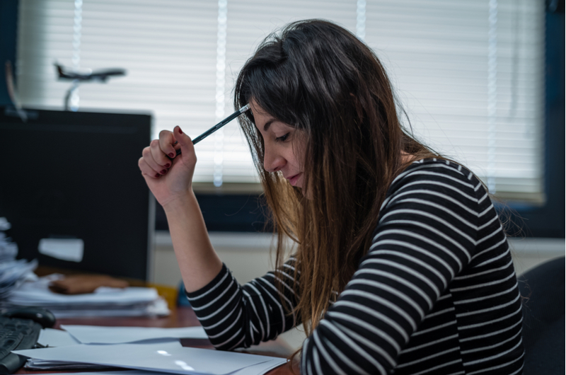 Woman struggling to solve a problem, needing to sleep on it