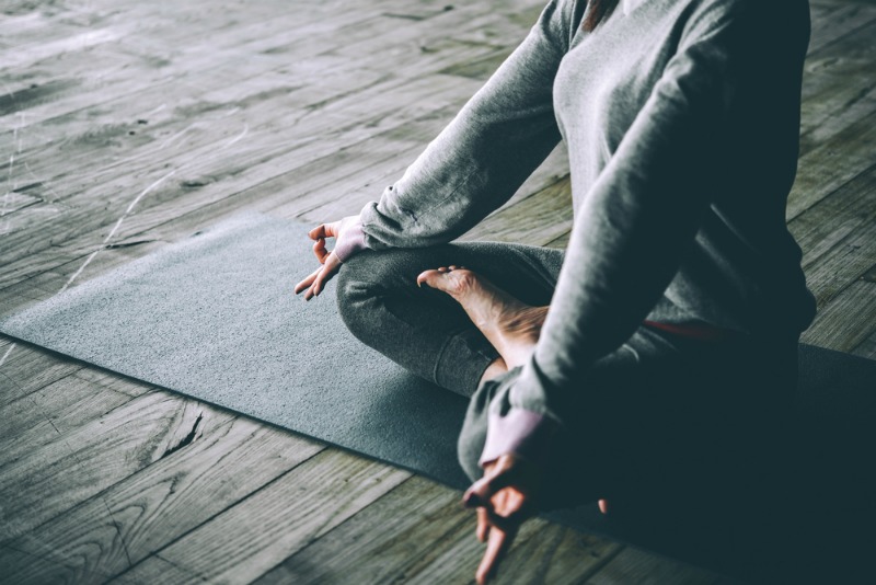 An image showing a woman practising yoga